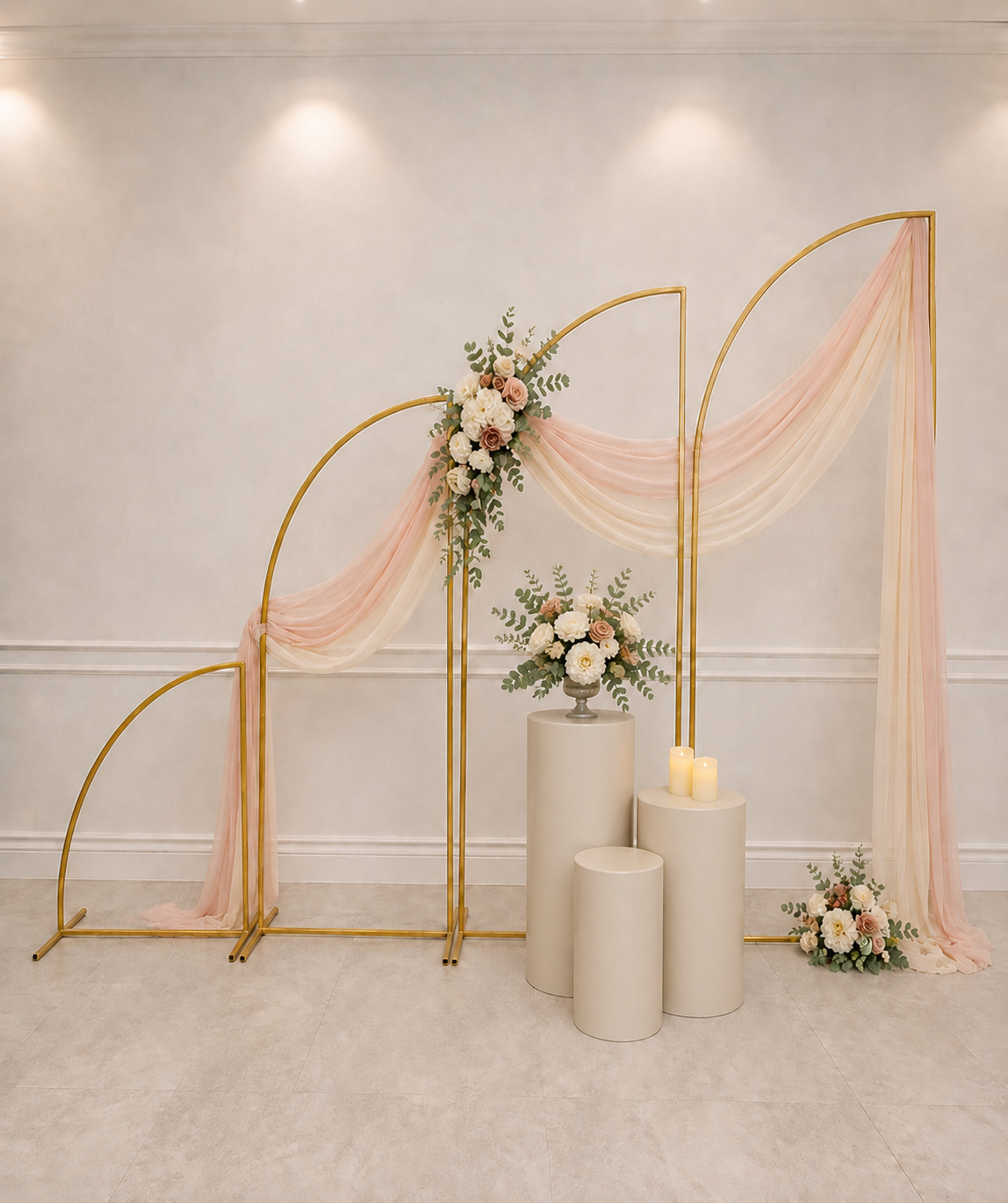 Gold arch backdrop with balloons and floral accents